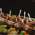 a tray of appetizers with toothpicks on them