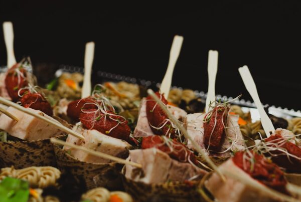 a tray of appetizers with toothpicks on them