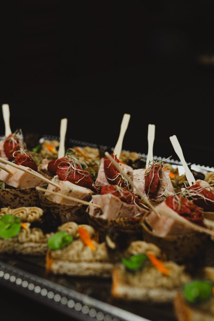 a tray of appetizers with toothpicks on them