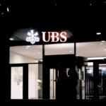 a person standing outside of a building at night